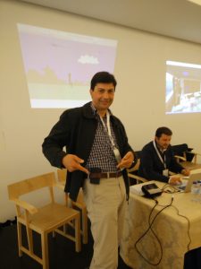 Researcher standing in front of a projection screen at the convention