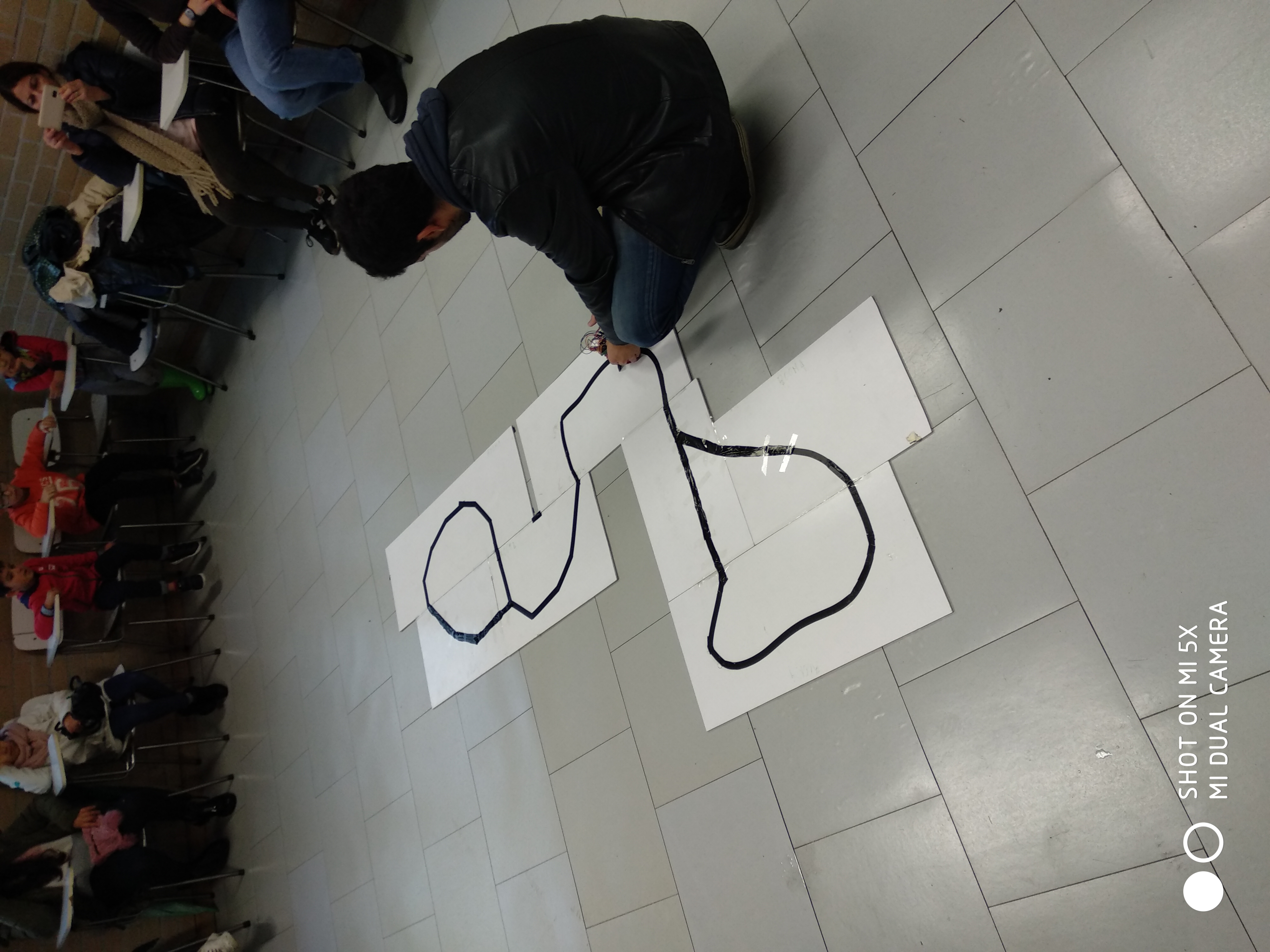 Researcher drawing a black line track on white sheets on the floor