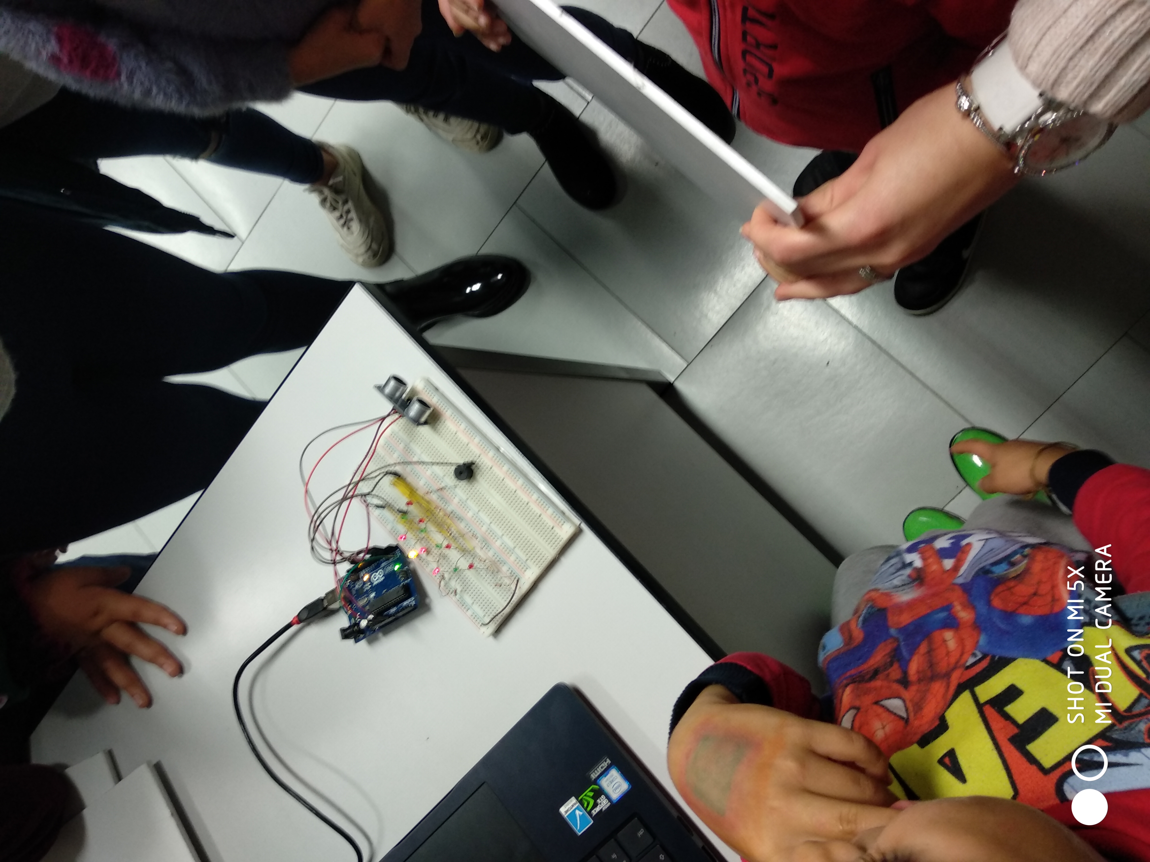Arduino and breadboard circuit shown to the children