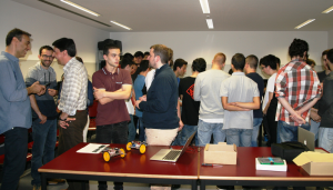 Group of students watching a robot demonstration