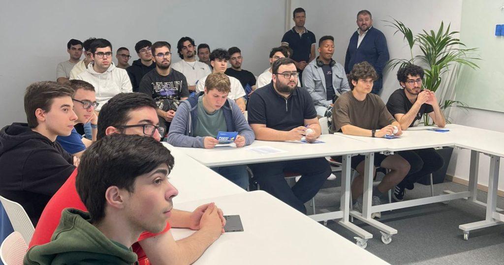 Informatics Engineering students seated in a meeting room at Critical Manufacturing